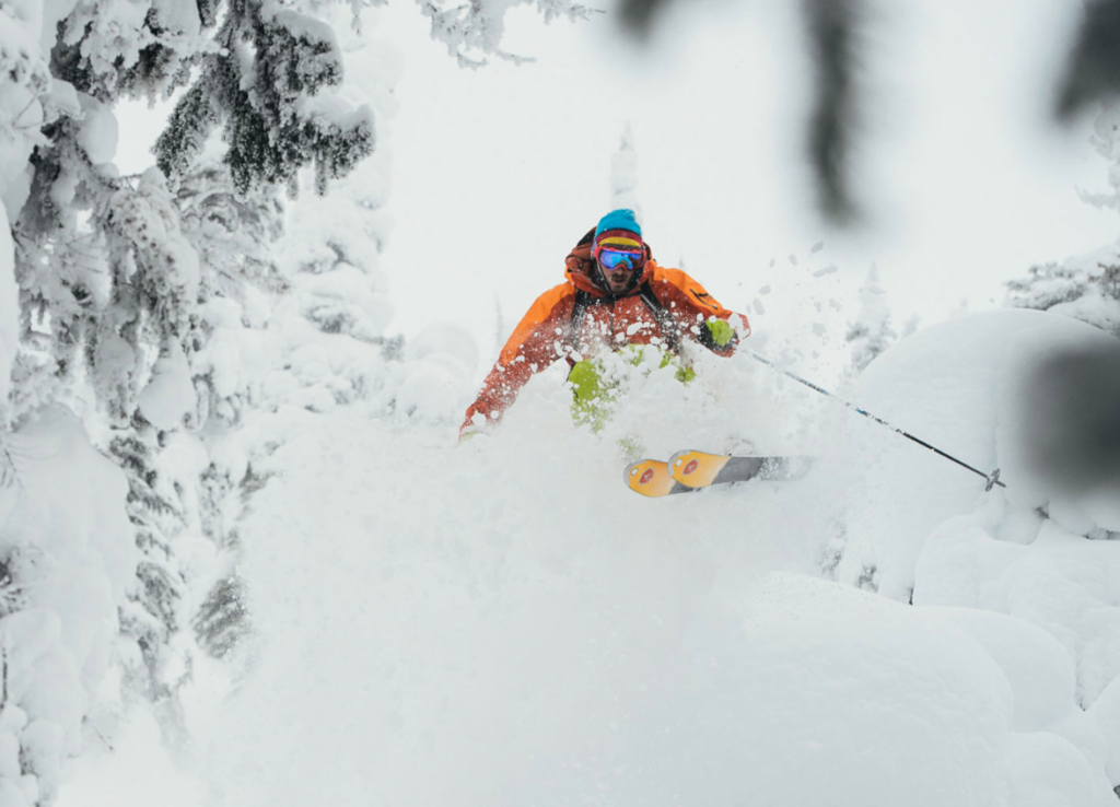 skier forrest coots jumps through powder