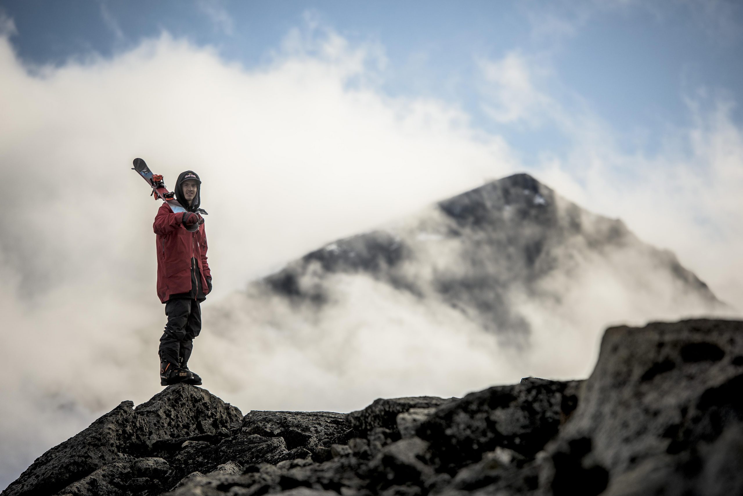 Skier stands with skis on mountain