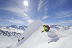 skier and shadow high on mountain top