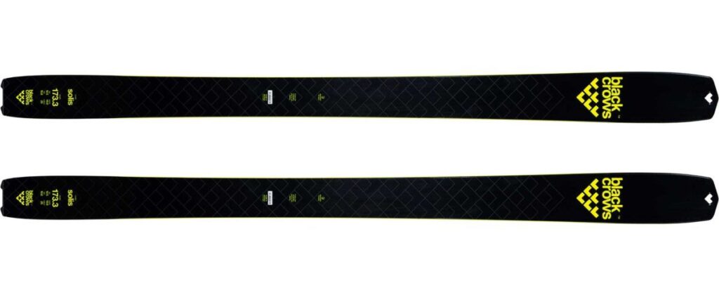 Black skis, yellow Black Crows branding logo printed on nose of skis, in image product