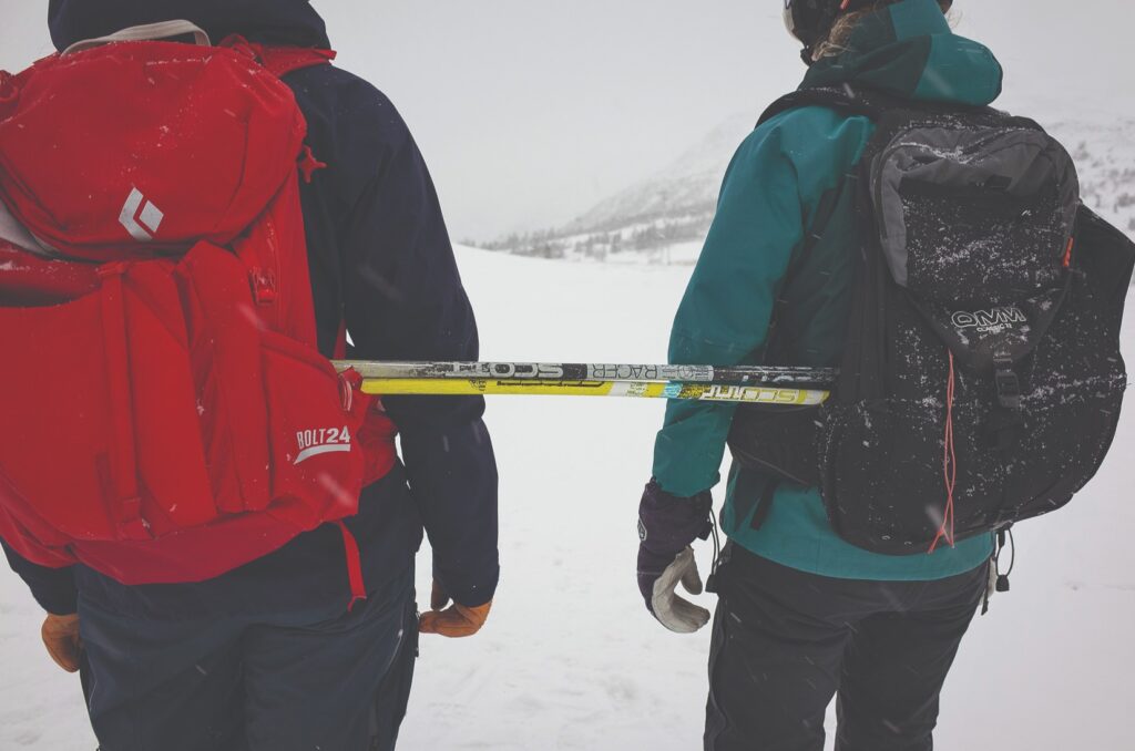Ski poles being used to carry an injured skier