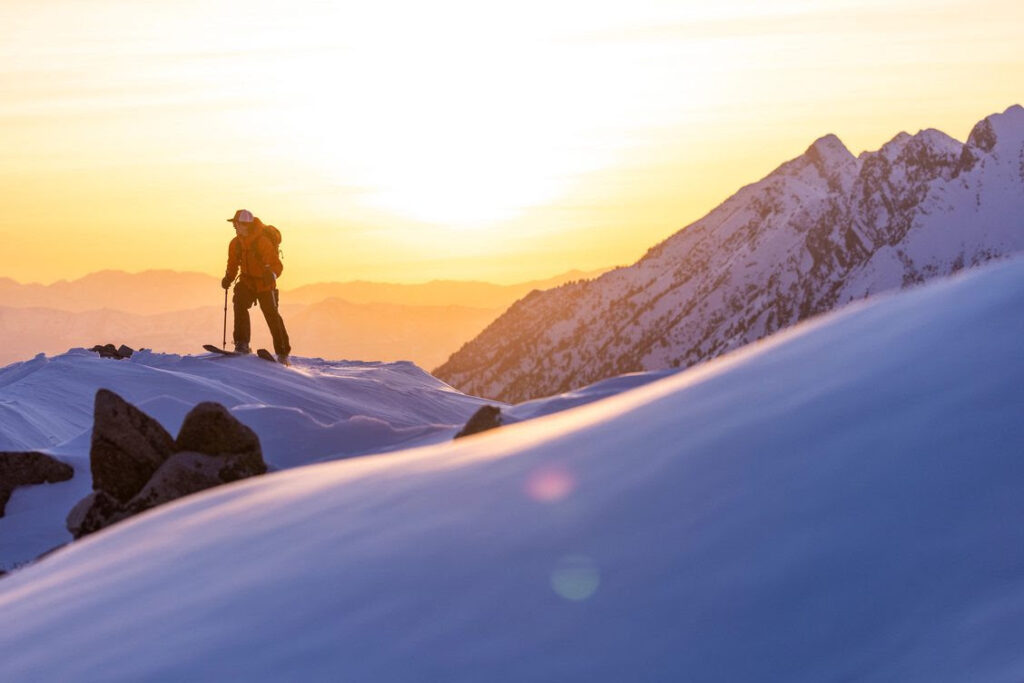 skier on mountaintop at dawn
