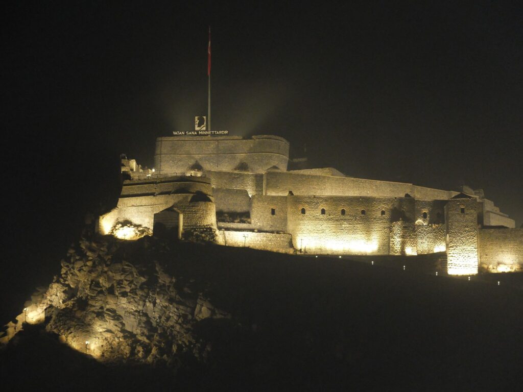 historic Kars castle like building by night, lit up