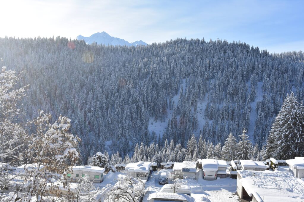 snowy caravan roofs looking sleepy with big mountain backdrop and views