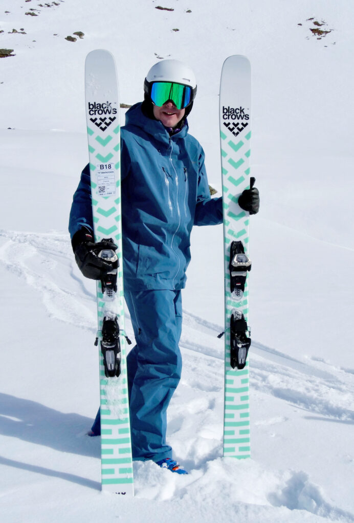 Fall Line ski tester Andy Townsend poses with Black Crow fat skis on snow