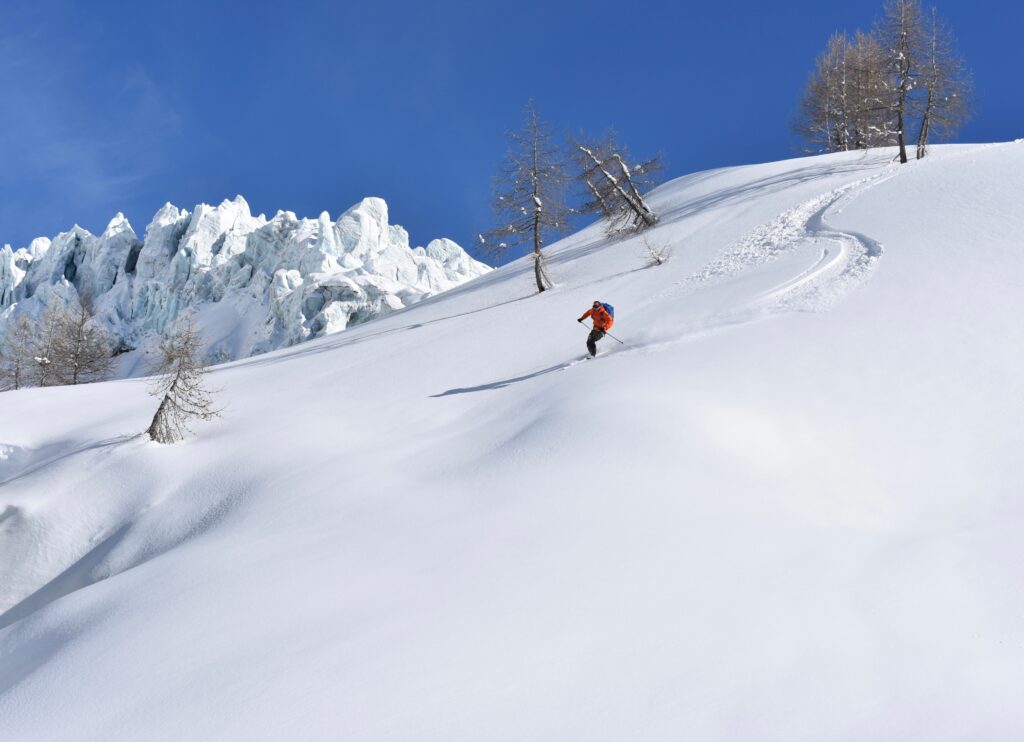 skier making fresh tracks in front of high rising seracs of the Argentiere glacier