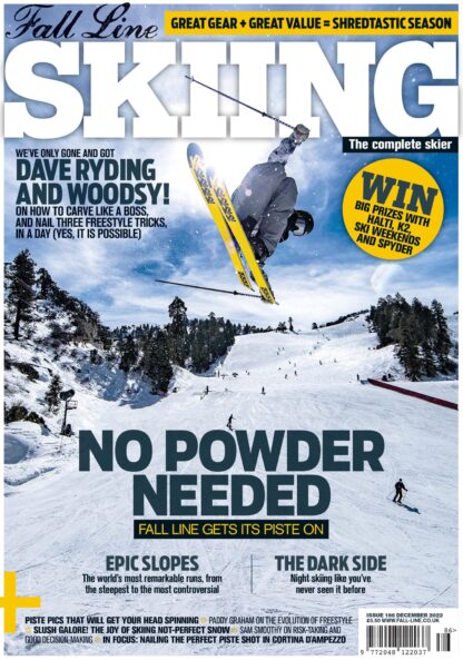 magazine cover of the Fall Line Skiing magazine issue 186. A skier jumps over the piste doing a tail grab with yellow bases on skis. piste skiers ski on in the background