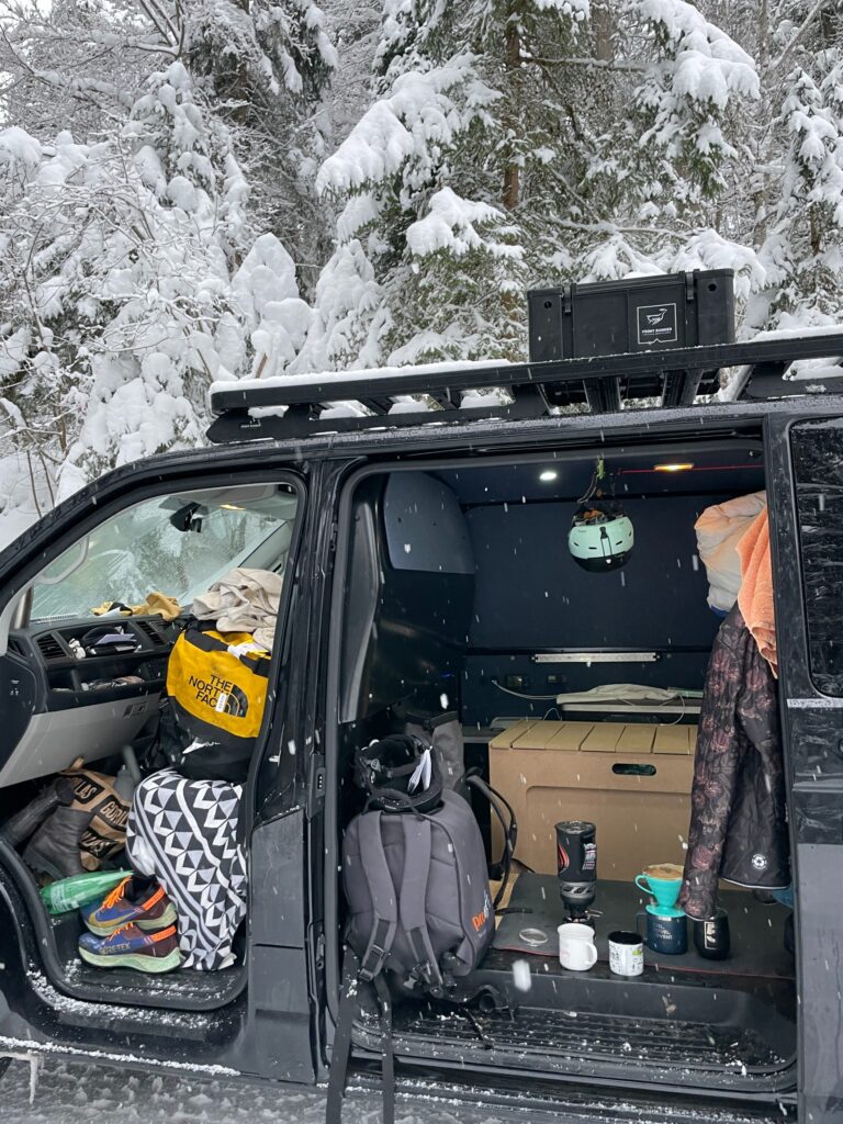 interior of a messy van surrounded by snow