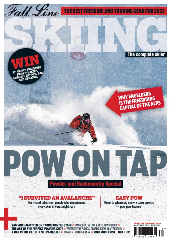 front cover of Fall Line magazine's powder and backcountry issue. The qhole cover has a sprayed powdery effect, as a skier in red skis through dust cloud