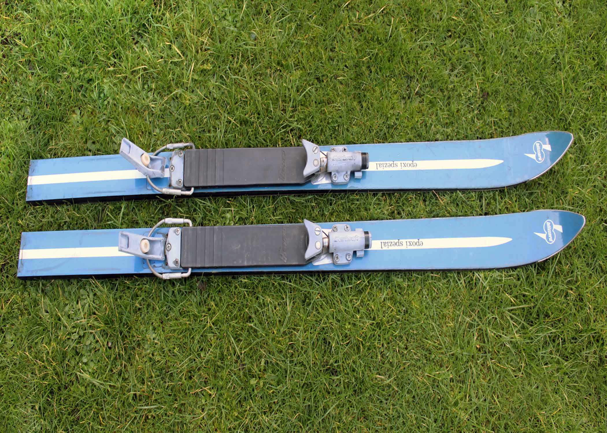 1973 blue coloured Blizzard skis shortened by about 50%, pictured on grass