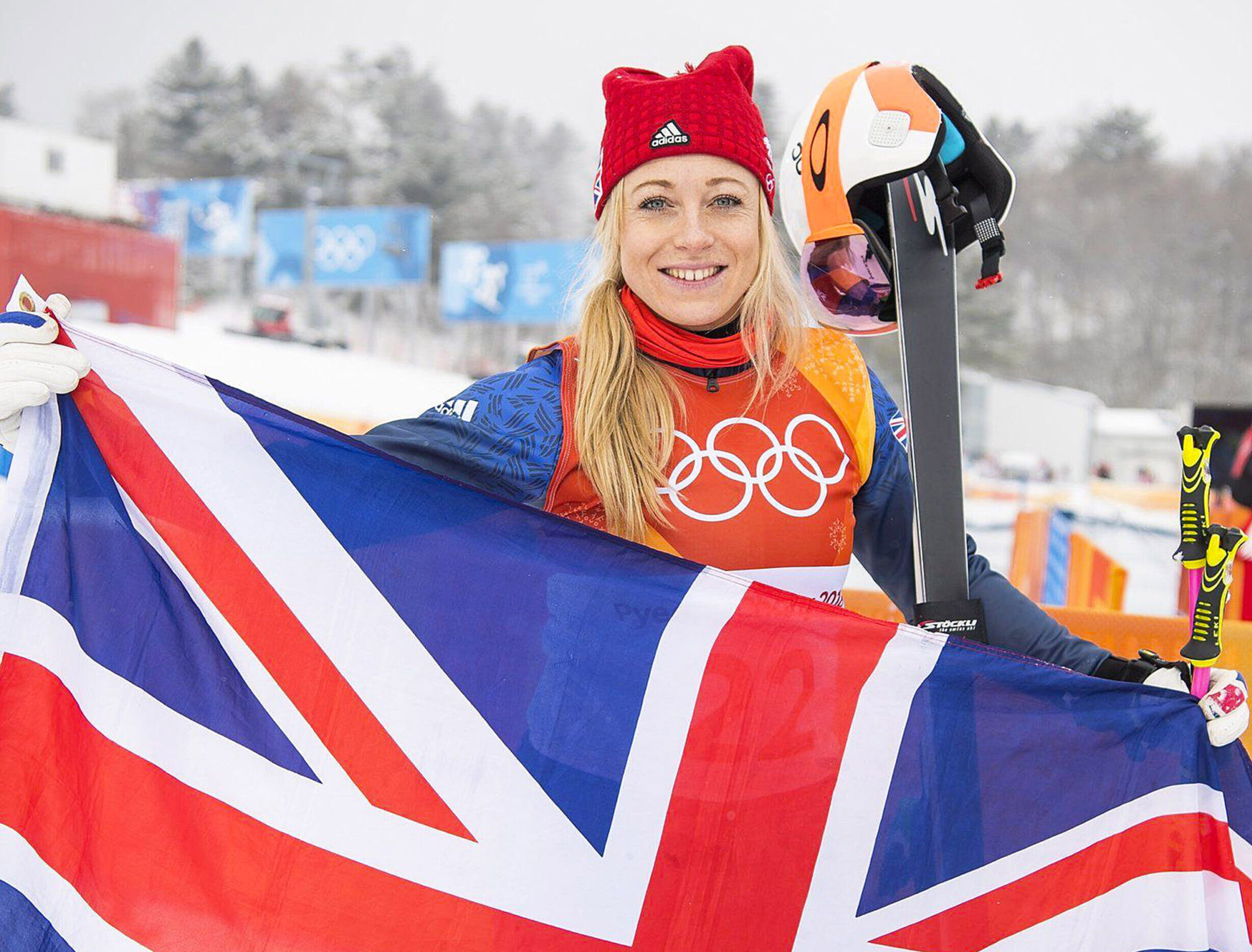 former ski cross athlete Emily Sarsfield stands behind huge Union Jack