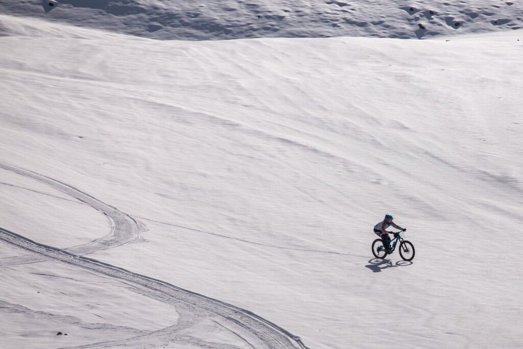 lone mountain biker on snow