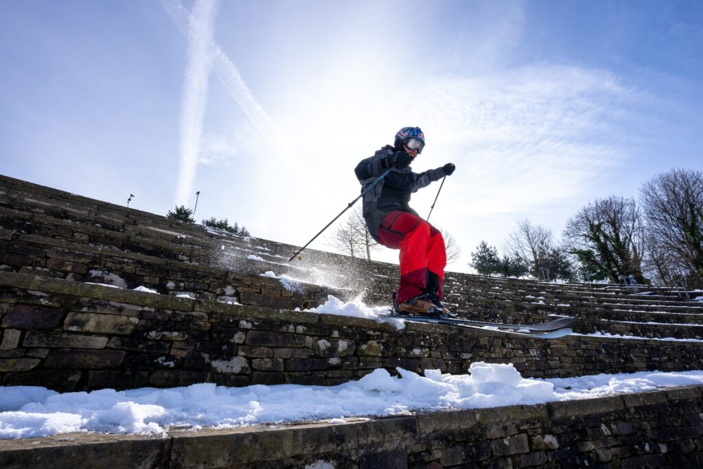 skier Paddy Graham skis idown snow and stone steps
