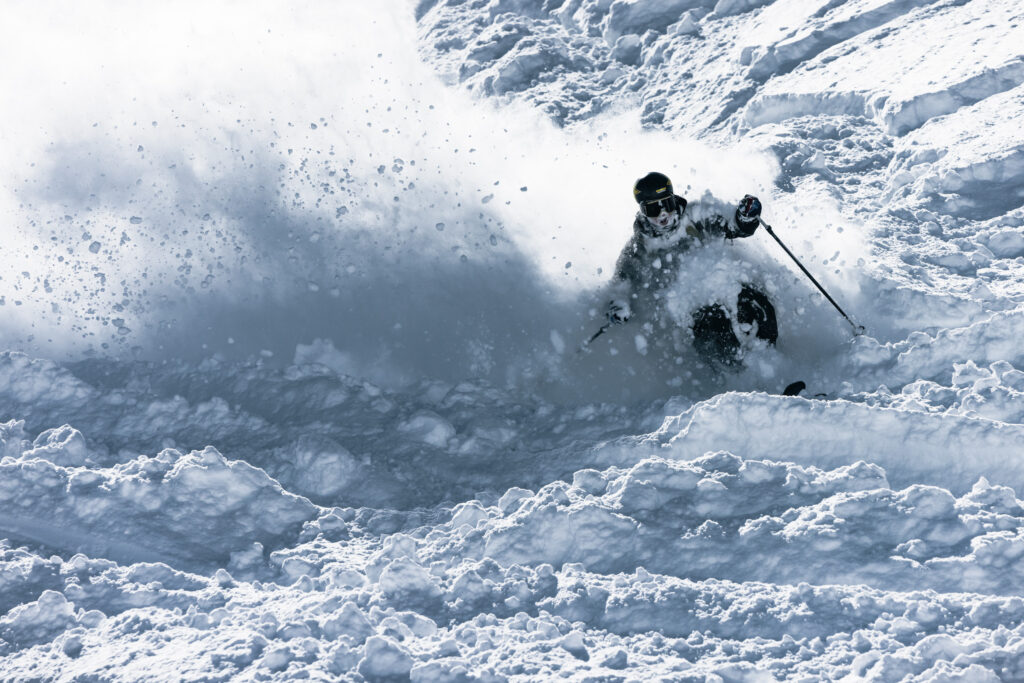 A skier in deep pow, face caked in snow