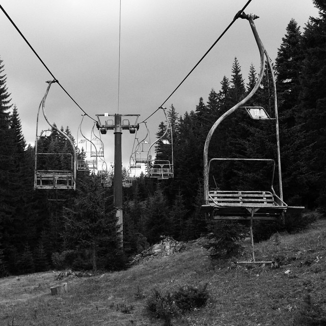a closed chair lift photographed in black and white