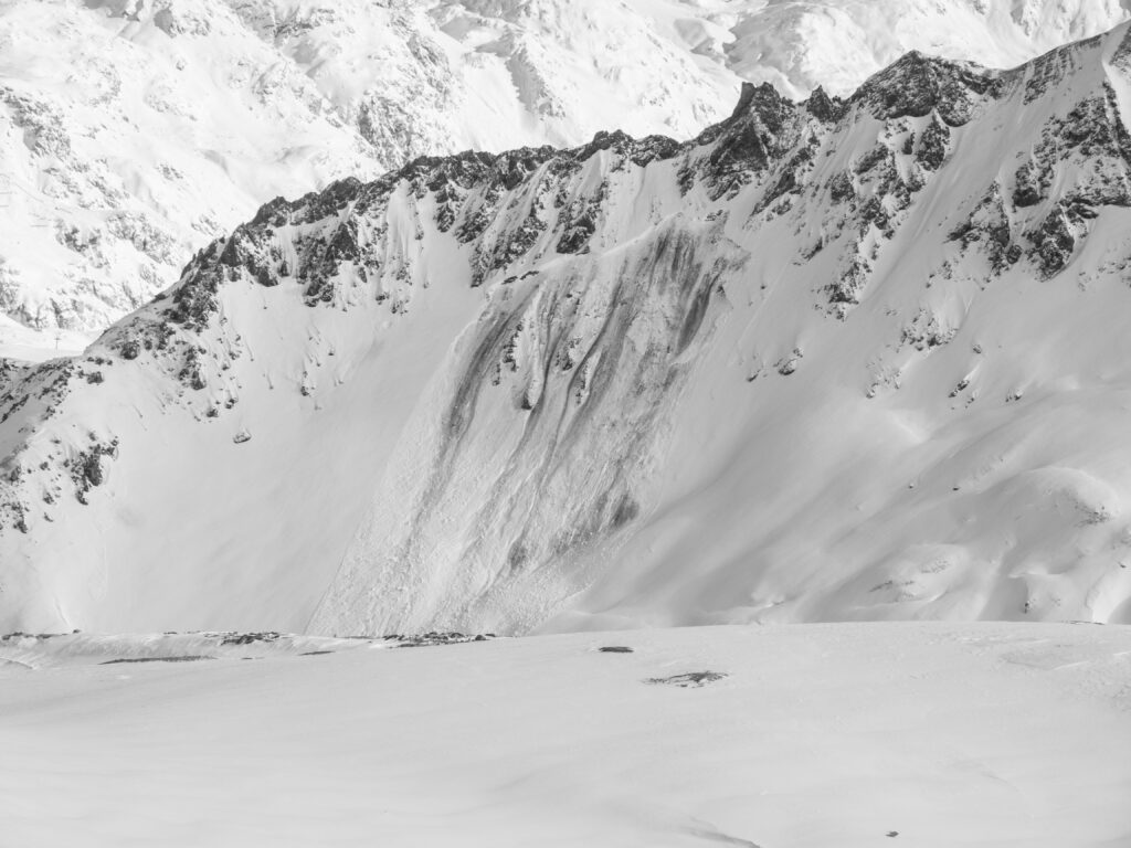 An avalanche shot from afar in black and white