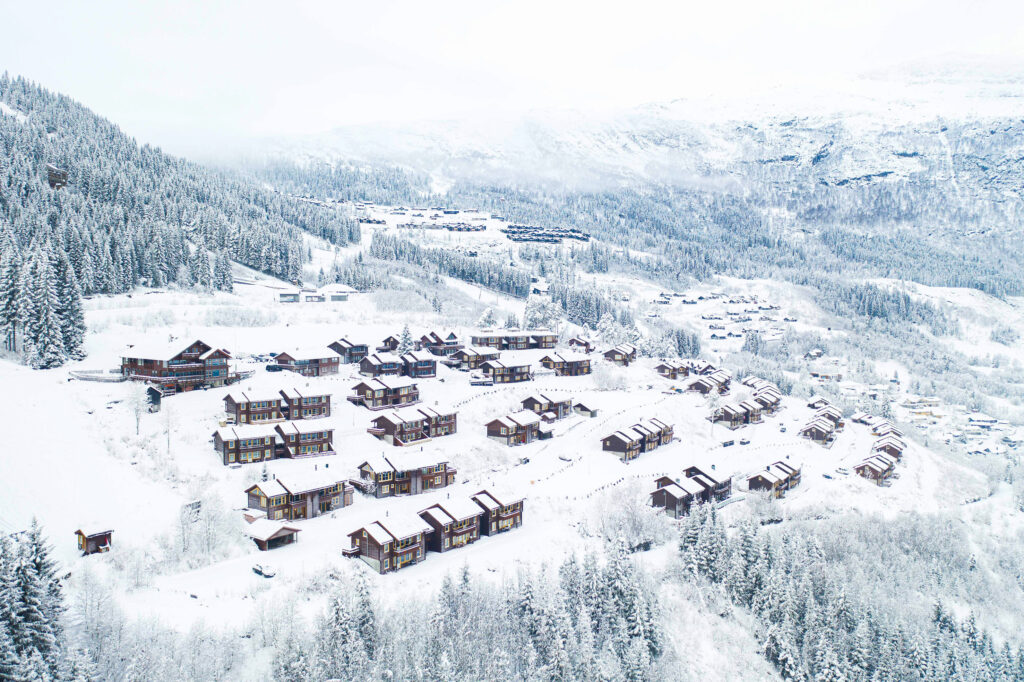 cabins covered in snow are pictured from above