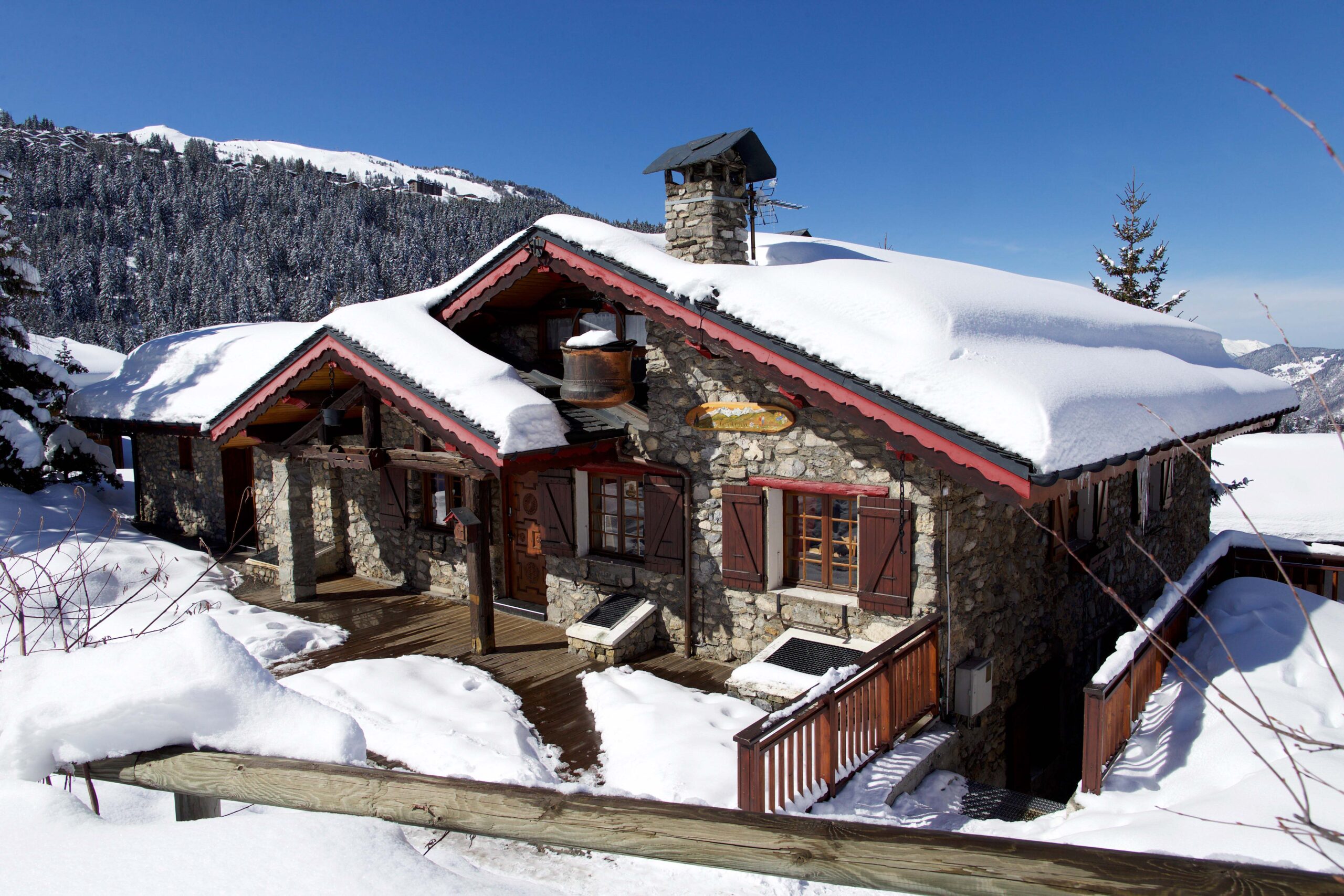a chalet with its roof covered in snow