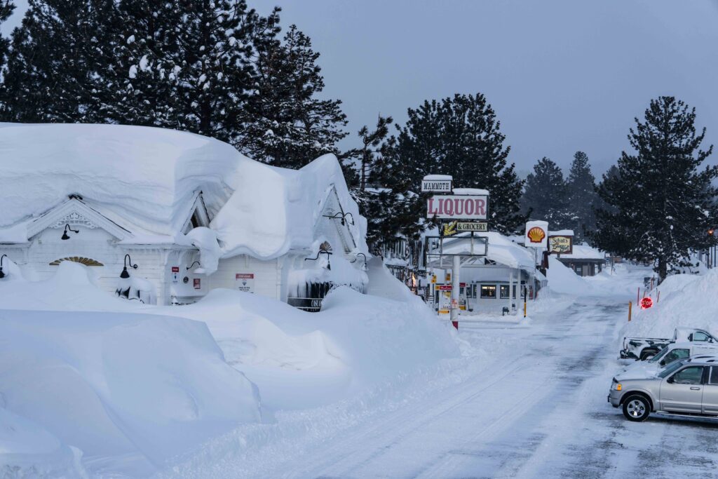 a town's street is pictured under heavy snow
