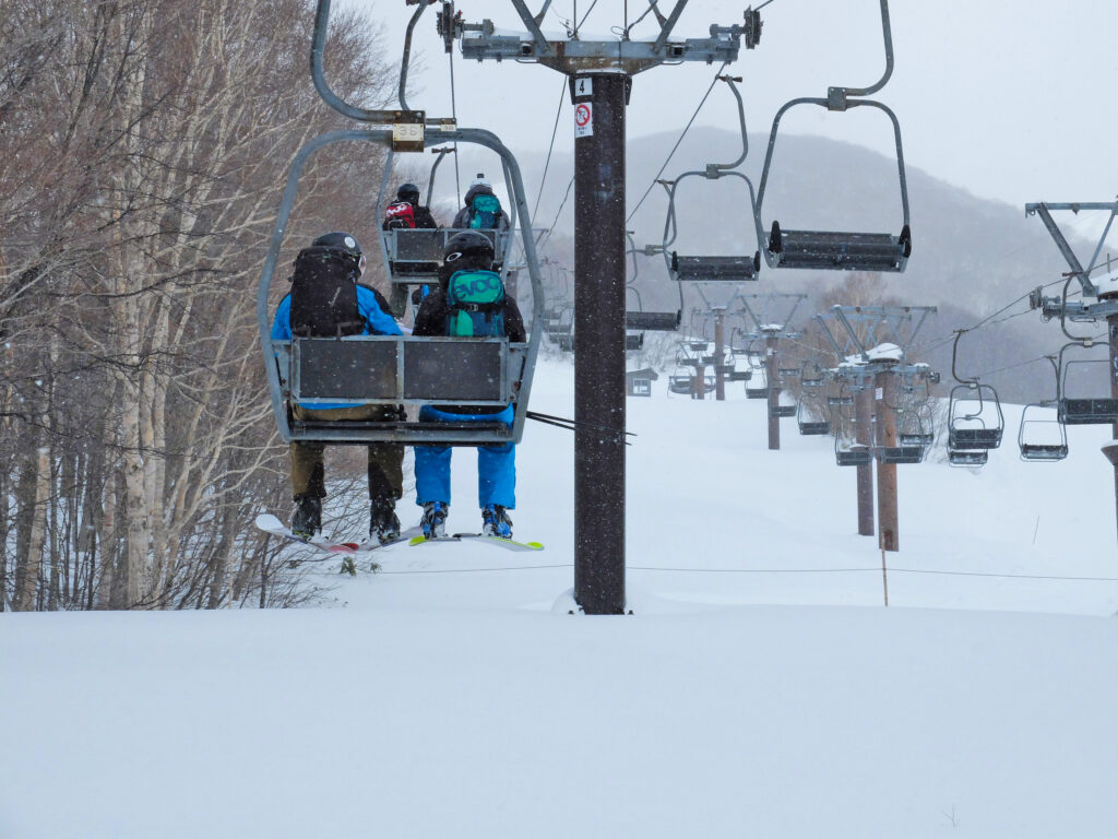 a chairlift in a snowy setting