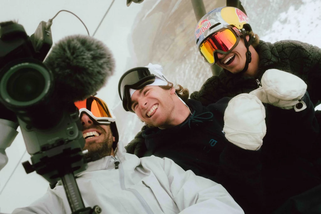 three skiers smiling behind the camera