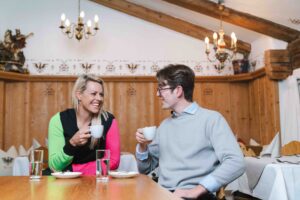 ex ski racer Chemmy Alcott chats over a cup of coffee to Austrian Elias from Seefeld in a wood-clad cabin