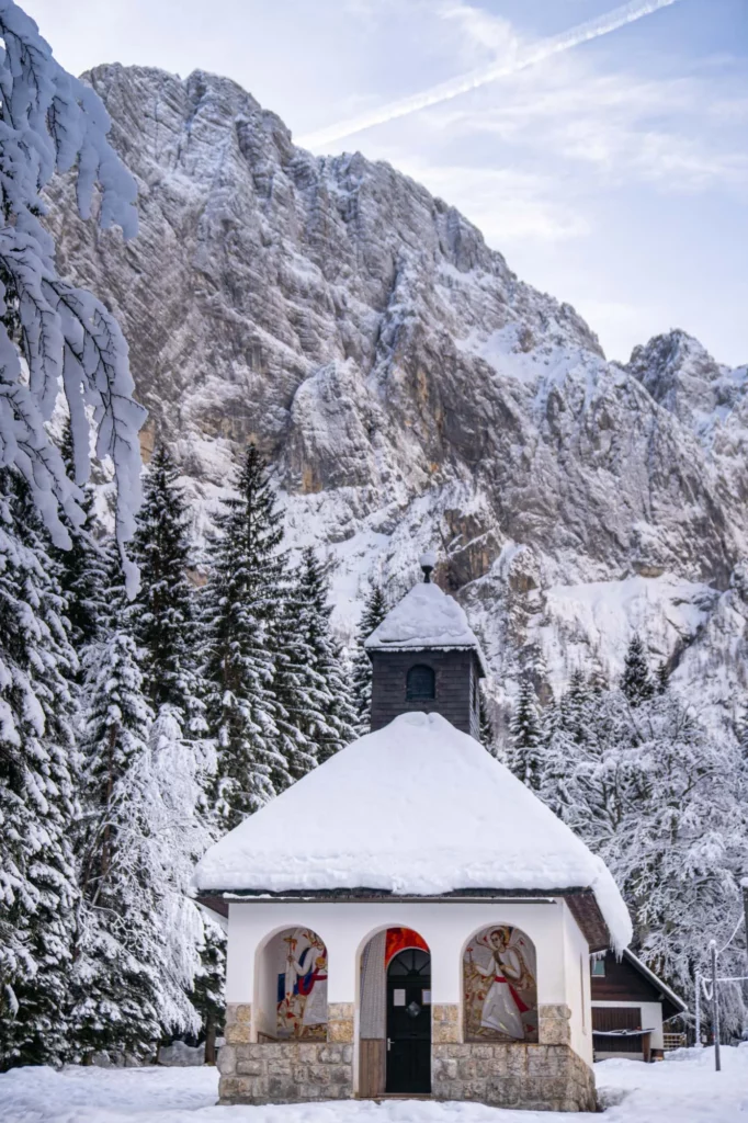 a slovenian mountain chapel covered in snow