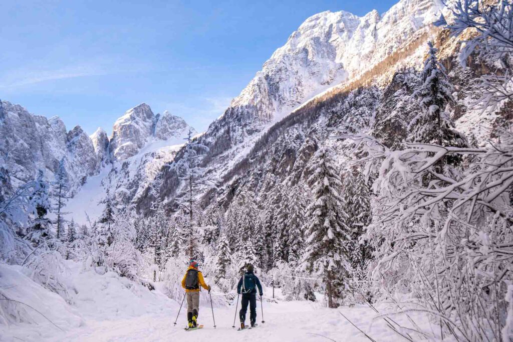 ski touring in Julian alps, big, steep mountains dusted in fresh snow