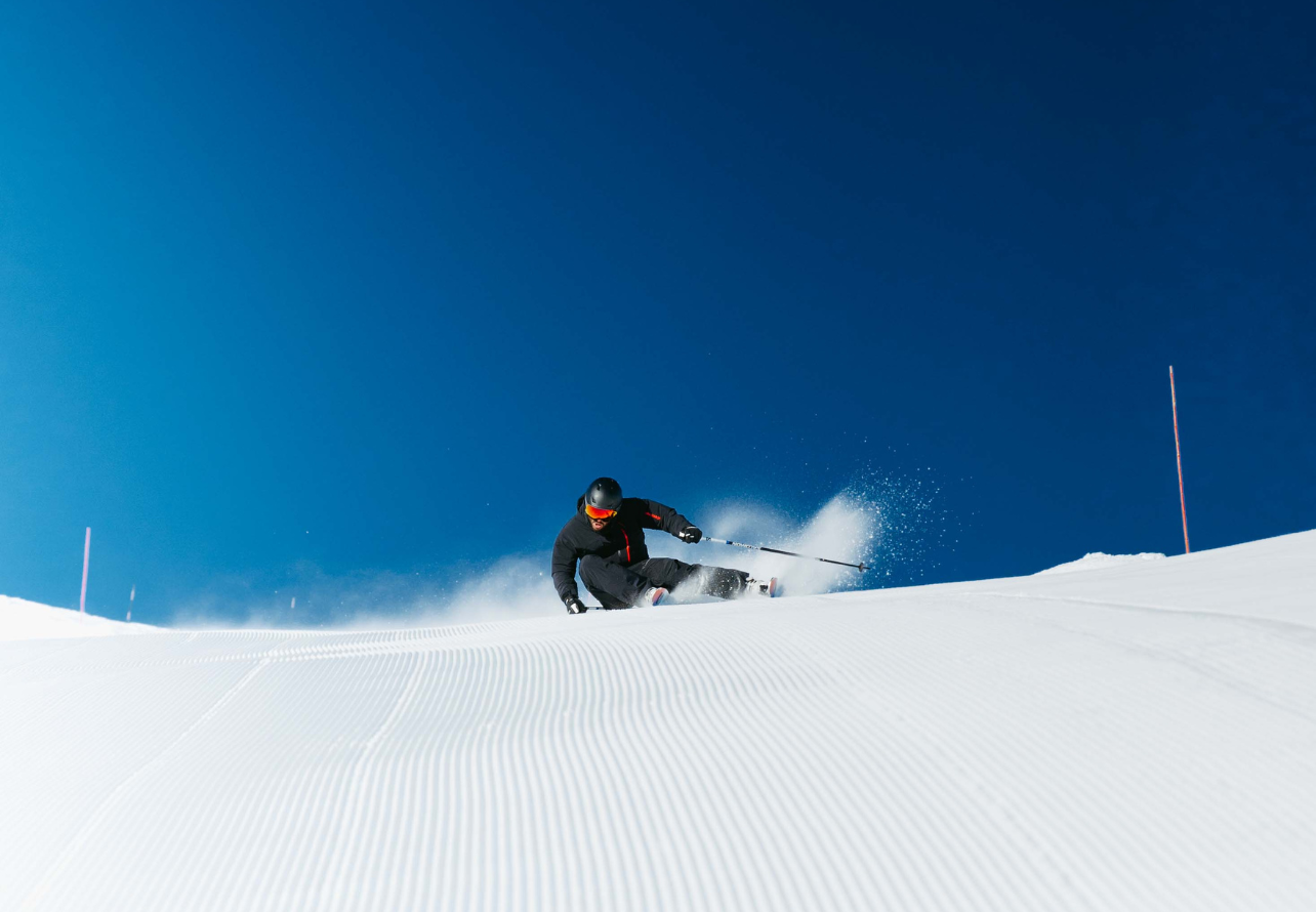 a deep carve on pristine piste