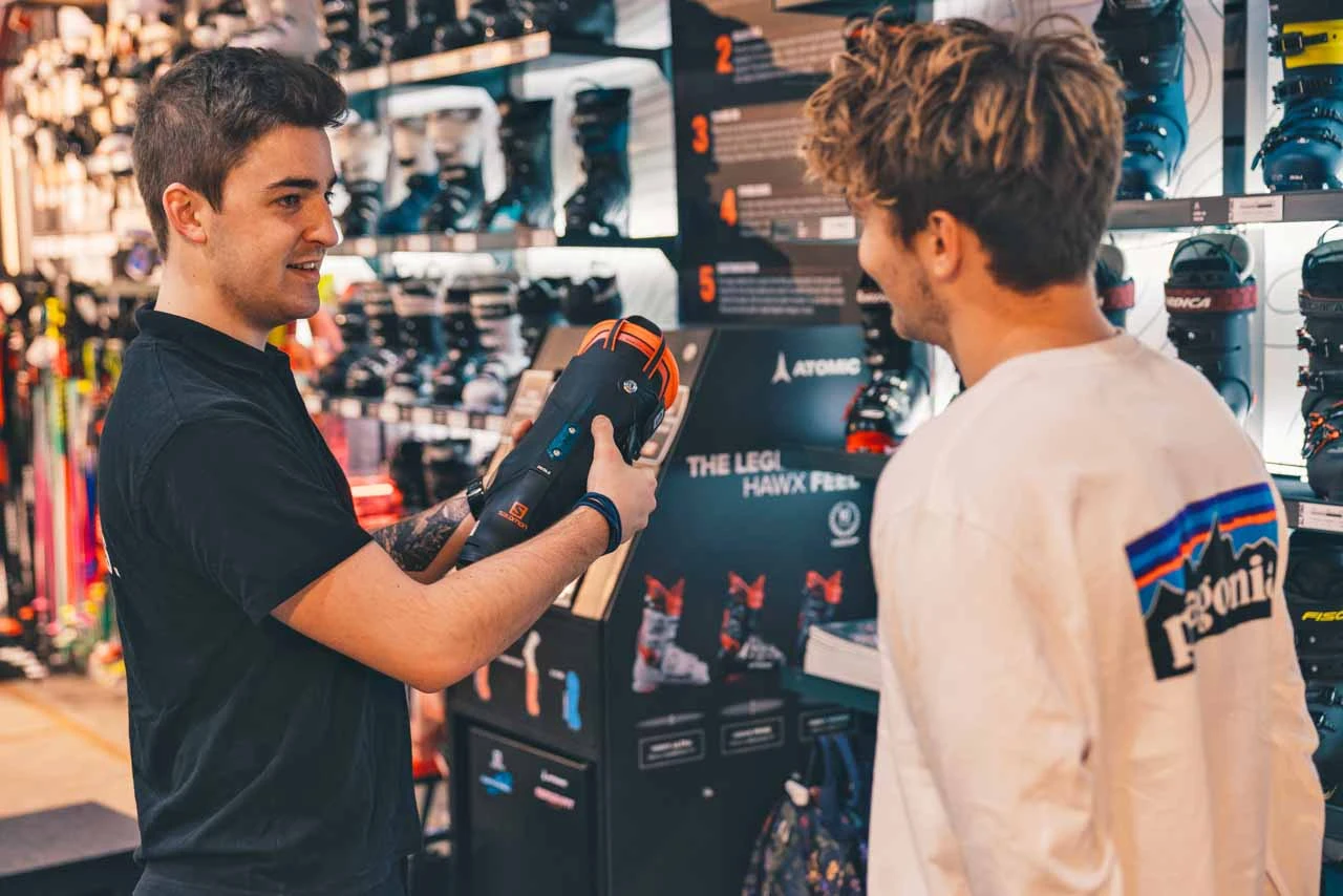 a boot fitter advises a customer