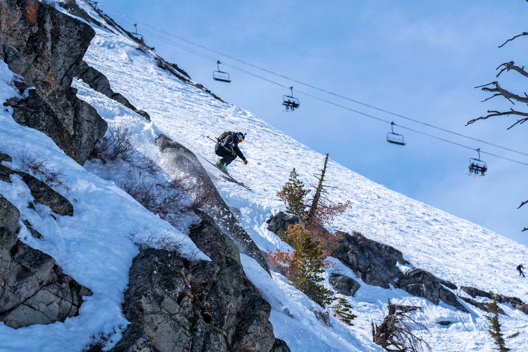 a skier jumps over rocks