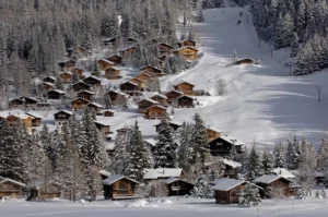 wood chalets on a snowy slope