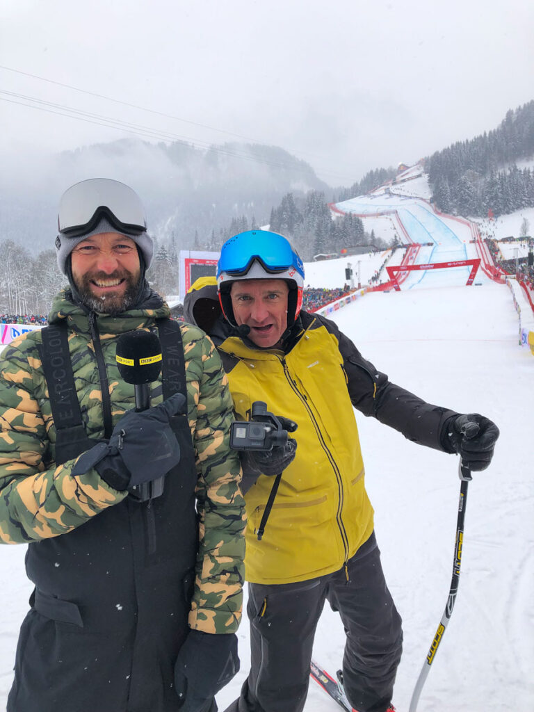 two Ski Sunday presenters smile into camera at the bottom of the Hahnenkamm