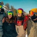 friends all in ski goggles posing for photo