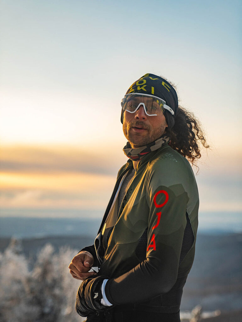 headshot of ski touring Noah Dines, wearing a bandana and wrap around glasses